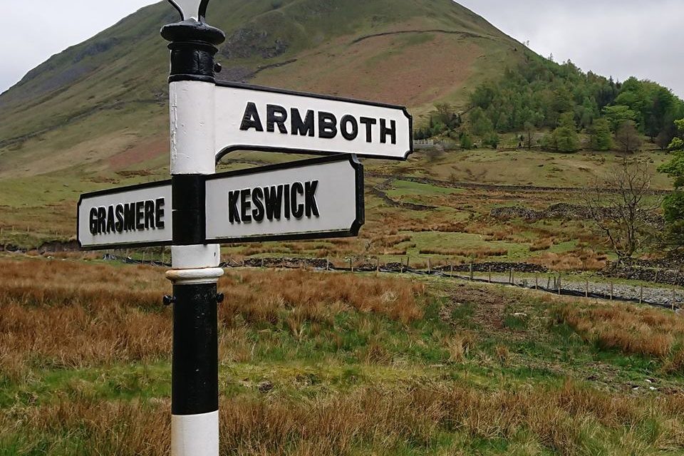 A signpost with arms pointing to four different places