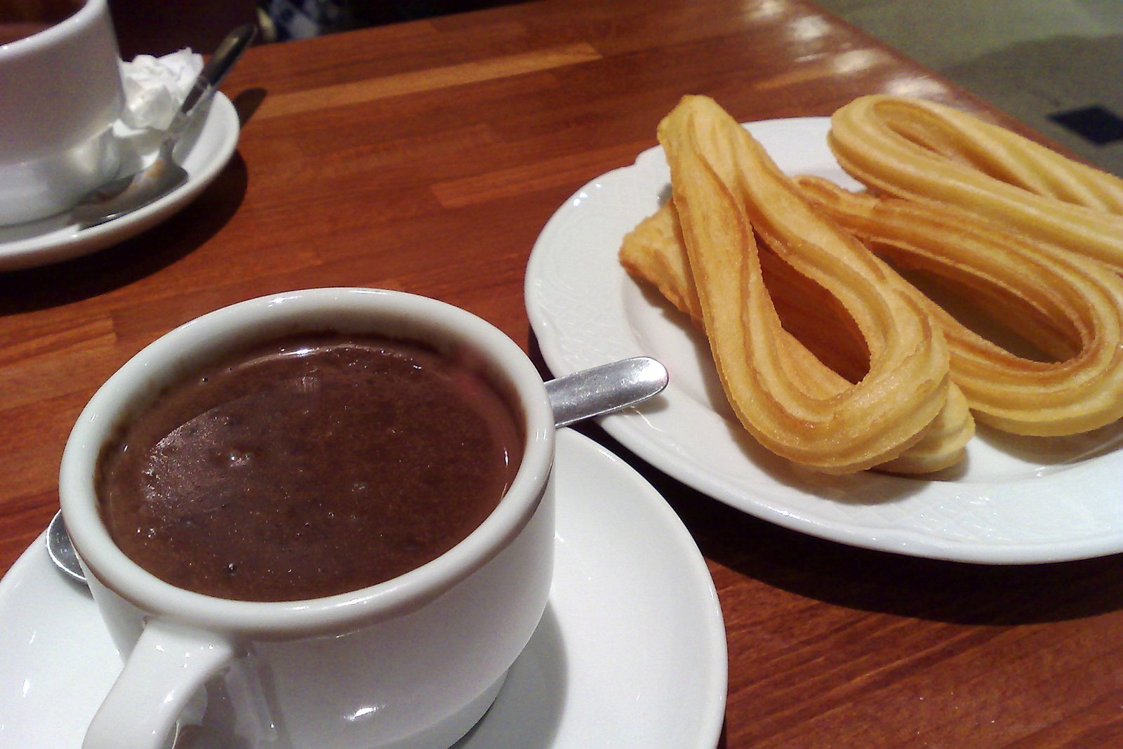 A cup of hot chocolate with churros